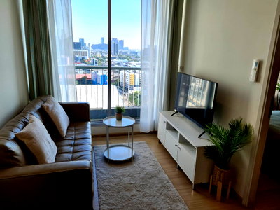 Condos for sale : Rhythm Sukhumvit 50, a room decorated in light wood tones, looks comfortable on the eyes. There is a sofa. at the best price